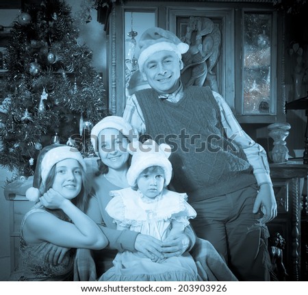Imitation of antique photo of happy  family posing for Christmas portrait