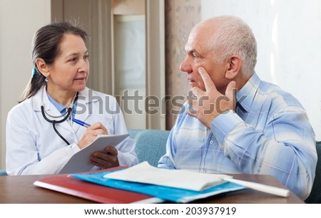 Medical consultation. Senior patient and doctor talking at table