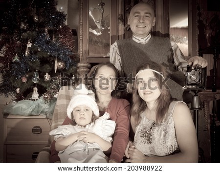 retro photo of Christmas portrait of happy family of photographer