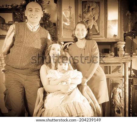 antique portrait of happy family with Christmas tree at home