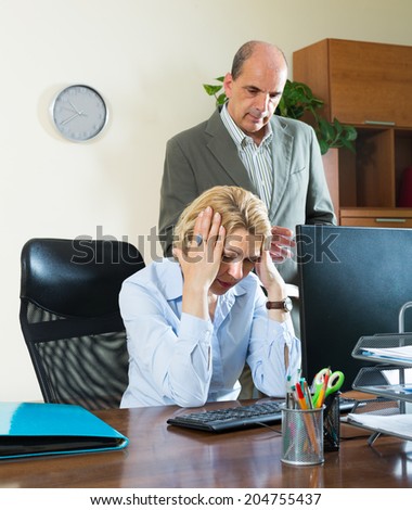Office scene with angry chief and careless elderly secretary