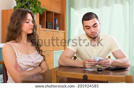 Financial problems in family. Sad couple with money