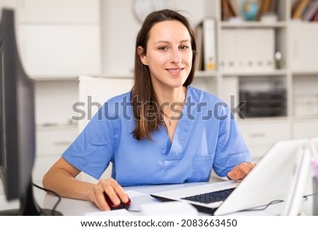 Woman doctor sitting at workplace with computer in her office ストックフォト © 