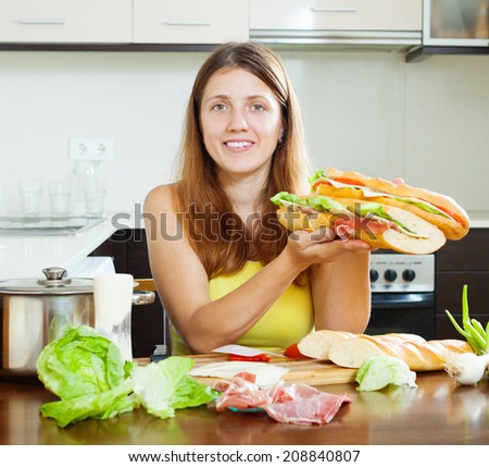 woman  with cooked  spanish sandwiches (bocadillo) in home kitchen