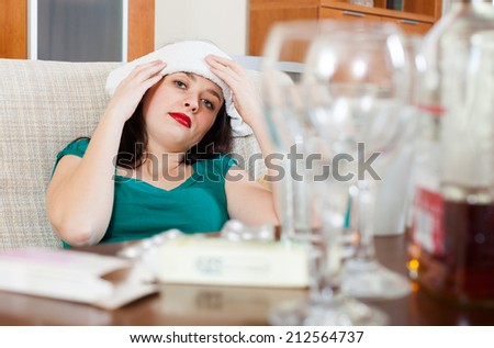 Woman having headache in morning after party