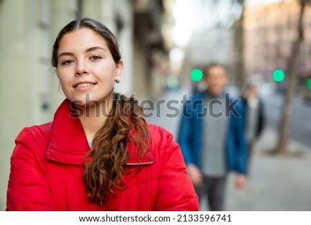 Attractive girl in jacket standing with electric scooter outdoors, ready to ride on spring city streets ストックフォト © 