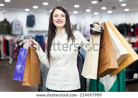 Portrait of happy female buyer with shopping bags