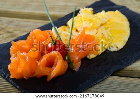 Dish of Norwegian cuisine of cooked omlette fried and served with salmon served at plate Stock fotó © 