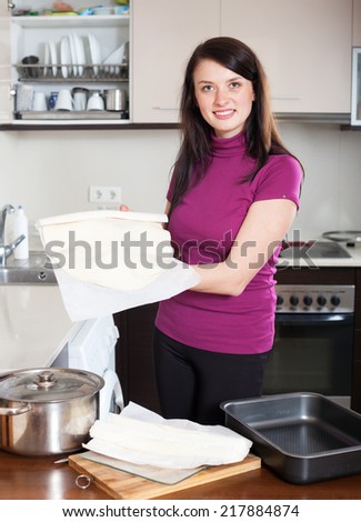Girl cooking with prepared store-bought dough at home kithen