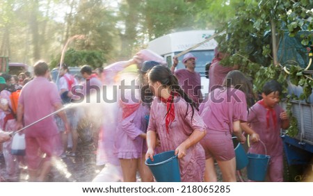 HARO, SPAIN - JUNE 29, 2014: People during Batalla del vino - wine madness in Haro, Spain. People fighting with wine from botas, bottles and buckets