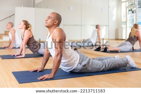 Image, Stock Photo Male making yoga exercise near window