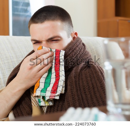illness ordinary  man in warm plaid with handkerchief