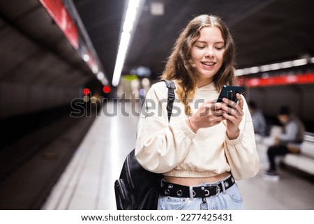 Similar – Image, Stock Photo Young woman waiting for subway train in New York City