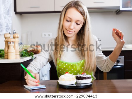 Woman weighing cakes on kitchen scales