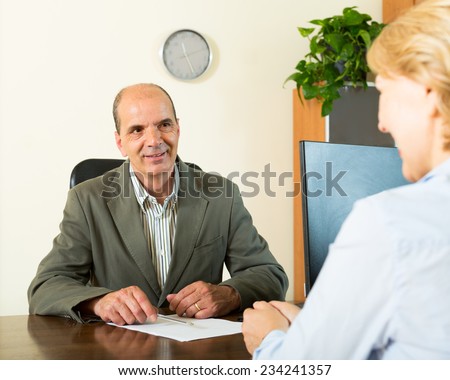 Happy client talking with manager at notary\'s office