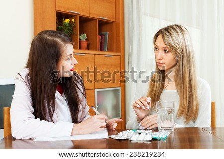 Smiling female doctor prescribing medication to  woman. Focus on patient