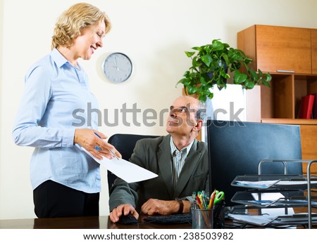 scene of two aged and happy co-workers in office