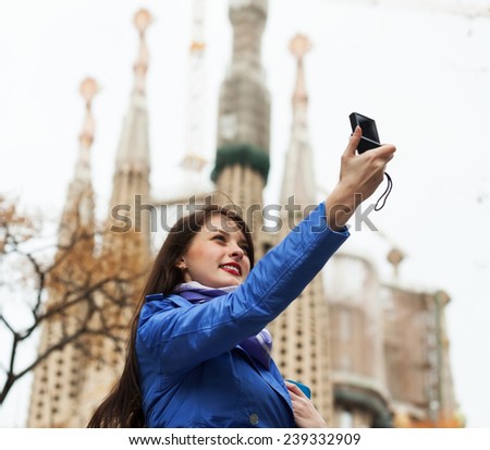 Female tourist with digital camera photographing  Sagrada Familia at Barcelona