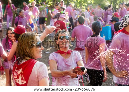 HARO, SPAIN - JUNE 29, 2014: Happy women during Batalla del vino - wine madness in Haro, La Rioja