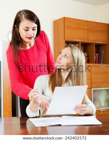 serious women with financial documents at table