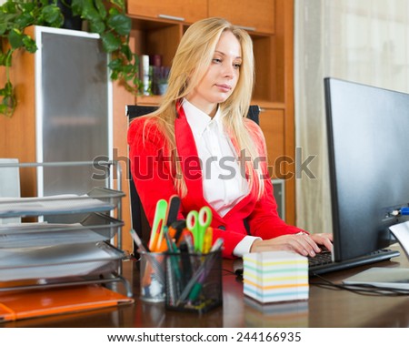 businesswoman  in red working with   computer at office
