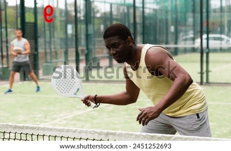 Similar – Image, Stock Photo Concentrated black man playing basketball on court