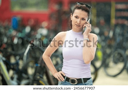 Similar – Image, Stock Photo Woman with bicycle seeks way on smartphone