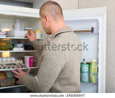 Man searching for food in the fridge