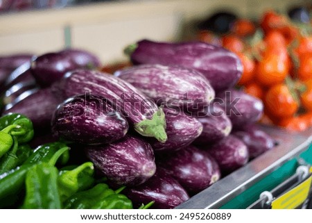 Fresh eggplant laid on wooden cutting board