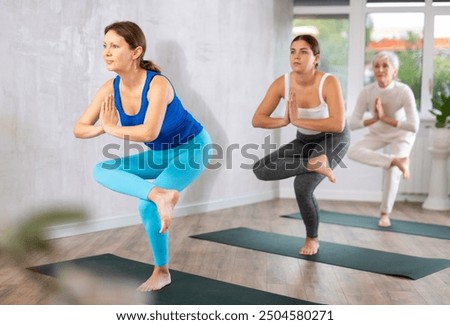 Similar – Image, Stock Photo Sportive woman performing yoga pose in room