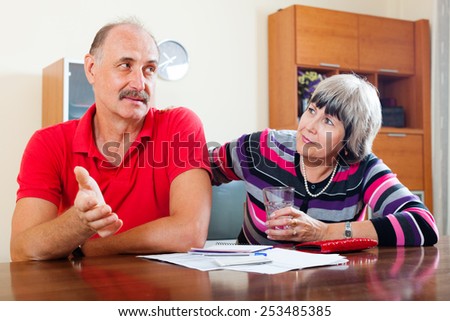 Financial problems in the family. Mature woman asks for money from her husband for the purchase