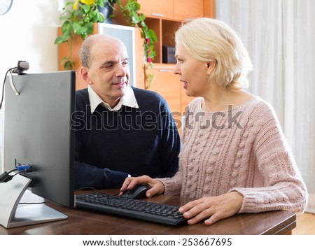 Senior mature couple using PC for video calls at home