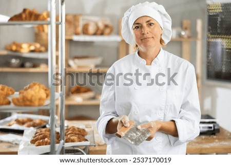 Similar – Image, Stock Photo Cook cutting dough with knife in shape on table