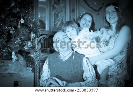 Retro photo of happy  family of three generations celebrating Christmas at home
