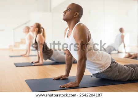 Similar – Image, Stock Photo Male making yoga exercise near window