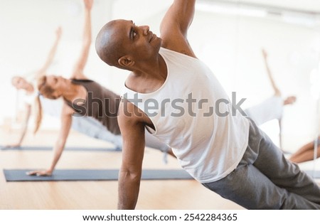 Similar – Image, Stock Photo Male making yoga exercise near window