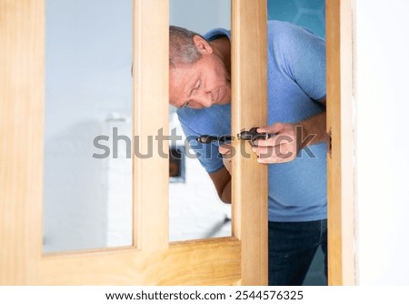 Image, Stock Photo Aged repairman in professional workshop with tools