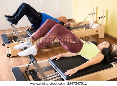 Image, Stock Photo Man and woman practicing yoga together in downward facing dog pose