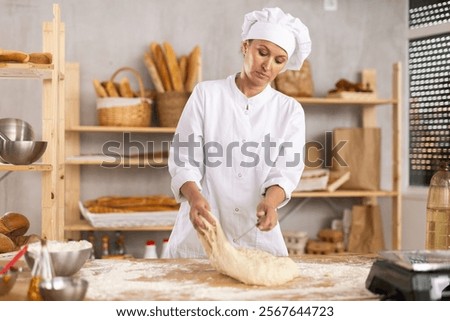 Image, Stock Photo Cook cutting dough with knife in shape on table