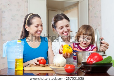 Happy family together cooking lunch with vegetables