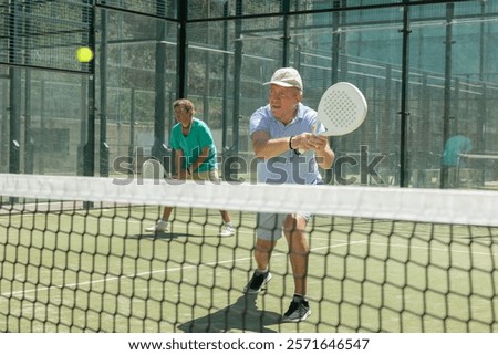 Similar – Image, Stock Photo senior man playing paddle tennis at indoors pitch, he is tired