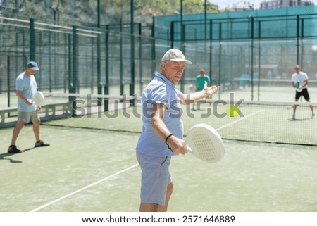 Similar – Image, Stock Photo senior man playing paddle tennis at indoors pitch, he is tired