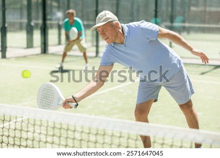 Similar – Image, Stock Photo senior man playing paddle tennis at indoors pitch, he is tired