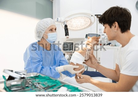 Similar – Image, Stock Photo Female veterinarian preparing dog for operation