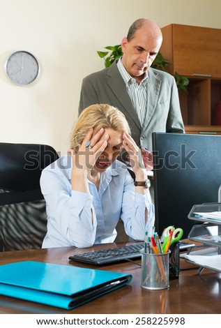 Office scene with angry aged chief and careless elderly female secretary