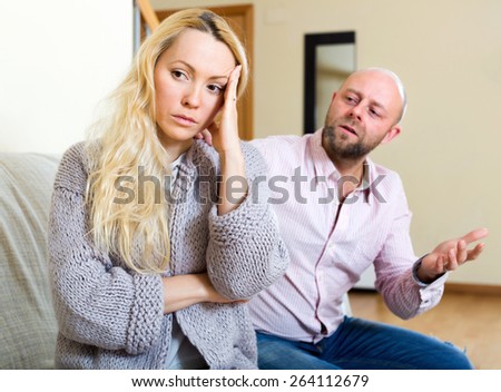 Man asking for forgiveness from long-haired woman