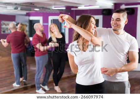 Young couples enjoying of partner dance and smiling indoor