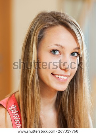 Beautiful smiling woman with long hair in the room