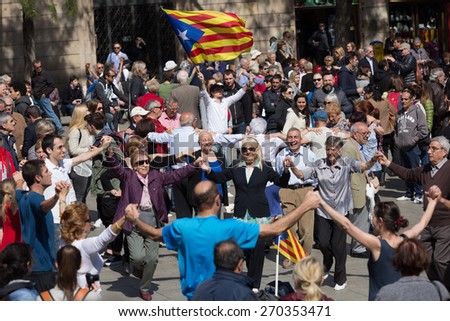 BARCELONA, SPAIN - APRIL 5, 2015: Mature people dancing circle dance long sardana at Catedral square