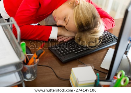 Young businessman sleeping in the office with her head on the table